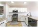 Well-lit kitchen featuring white cabinets, stainless steel appliances, and granite countertops at 4708 Grand Rock Dr, North Las Vegas, NV 89081