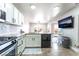 Stylish kitchen featuring granite countertops, white cabinets, and a breakfast bar at 4708 Grand Rock Dr, North Las Vegas, NV 89081
