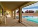 Back porch with chairs, swimming pool, and privacy wall at 5300 E La Terra Ave, Pahrump, NV 89061