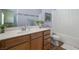 Stylish bathroom with a tub, toilet, light wood cabinet, and vanity area at 5300 E La Terra Ave, Pahrump, NV 89061