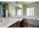 Bathroom with double sinks, soaking tub, and large mirror at 5300 E La Terra Ave, Pahrump, NV 89061