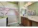 Bathroom features a tiled shower, vanity and sink with a large mirror at 5300 E La Terra Ave, Pahrump, NV 89061