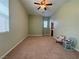 Spacious carpeted bedroom with ceiling fan, neutral walls, and rocking chairs for a cozy feel at 5300 E La Terra Ave, Pahrump, NV 89061