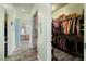 Hallway features a walk in closet and view into the bathroom with double sinks at 5300 E La Terra Ave, Pahrump, NV 89061
