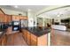 Modern kitchen island overlooks living space and features stainless steel appliances and wood cabinets at 5300 E La Terra Ave, Pahrump, NV 89061