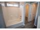 Clean bathroom with a bathtub and shower combination and an adjacent walk-in closet at 6652 Weeping Pine St, Las Vegas, NV 89149