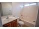 Well-lit bathroom with a shower-over-tub, single sink vanity, and white tiled shower walls at 6652 Weeping Pine St, Las Vegas, NV 89149