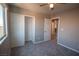 Neutral bedroom with gray carpet, a window for natural light, closet, and a ceiling fan at 6652 Weeping Pine St, Las Vegas, NV 89149