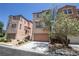 Exterior view of townhomes showing a garage and neatly landscaped front yards on a sunny day at 6652 Weeping Pine St, Las Vegas, NV 89149