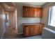 Upstairs hallway with built in wooden cabinets and a small window providing natural light at 6652 Weeping Pine St, Las Vegas, NV 89149