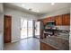 Well-equipped kitchen featuring stainless steel appliances and granite countertops, with a sliding glass door to a patio at 6652 Weeping Pine St, Las Vegas, NV 89149
