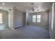Open living room with neutral carpet, ceiling fan, and ample lighting at 6652 Weeping Pine St, Las Vegas, NV 89149