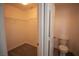 Bright walk-in closet with wire shelving, carpet flooring, and an adjacent toilet room at 6652 Weeping Pine St, Las Vegas, NV 89149