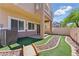 Backyard featuring artificial turf and a decorative rock garden at 1069 Thrill Ct # 102, Henderson, NV 89002