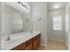 Bathroom featuring double sinks, a large mirror, and a separate shower area at 1069 Thrill Ct # 102, Henderson, NV 89002