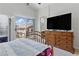 Sunlit bedroom with sliding glass doors to a balcony, dresser, and a ceiling fan at 1069 Thrill Ct # 102, Henderson, NV 89002