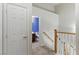 Bright hallway leads to a bathroom featuring a modern sink and vanity with neutral tile at 1069 Thrill Ct # 102, Henderson, NV 89002