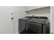 Functional laundry room with modern gray washer and dryer units at 1069 Thrill Ct # 102, Henderson, NV 89002