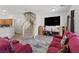 Open concept living room features a large screen tv, hardwood floors, and staircase at 1069 Thrill Ct # 102, Henderson, NV 89002
