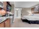Bedroom featuring kitchenette and direct access to a bathroom, great for convenience and privacy at 135 E Harmon Ave # 2515, Las Vegas, NV 89109