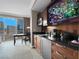 Close-up of a kitchenette with a mini-fridge, microwave, sink, and a mounted TV above the counter at 135 E Harmon Ave # 2515, Las Vegas, NV 89109