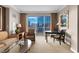 Living room area featuring comfortable seating, a desk, and a large window providing city views at 135 E Harmon Ave # 2515, Las Vegas, NV 89109