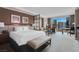 Bright main bedroom featuring a wet bar, desk, seating area, city views, and comfortable bed at 135 E Harmon Ave # 2515, Las Vegas, NV 89109