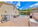 Expansive backyard featuring a sparkling pool, covered patio, desert landscaping, and blue skies at 1862 Redwood Valley St, Henderson, NV 89052