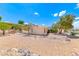 Backyard view of the single-story home featuring desert landscaping, rock accents, and a fenced pool at 1862 Redwood Valley St, Henderson, NV 89052