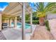 Inviting backyard patio with pergola, a palm tree, barbecue grill and a view of the pool at 1862 Redwood Valley St, Henderson, NV 89052