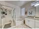 Bathroom boasts a granite countertop, double sinks, a bathtub, and a separate glass shower at 1862 Redwood Valley St, Henderson, NV 89052