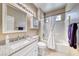 Bathroom features a single sink vanity with storage, a shower-tub combo, and natural lighting at 1862 Redwood Valley St, Henderson, NV 89052