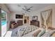 Bright bedroom features a ceiling fan, pool access, tile flooring, and an en suite bathroom at 1862 Redwood Valley St, Henderson, NV 89052