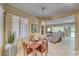 Bright dining room flows into the living room and features large windows and modern decor at 1862 Redwood Valley St, Henderson, NV 89052