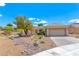 Charming single-story home features desert landscaping, a tile roof, and an attached two-car garage at 1862 Redwood Valley St, Henderson, NV 89052