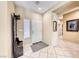 Bright foyer featuring a tile floor, coat rack, decorative mirror, and access to other rooms at 1862 Redwood Valley St, Henderson, NV 89052