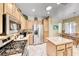 Spacious kitchen features stainless steel appliances, island, and wood cabinets for ample storage at 1862 Redwood Valley St, Henderson, NV 89052