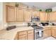 Well-equipped kitchen features wood cabinets, countertops, and stainless steel gas range at 1862 Redwood Valley St, Henderson, NV 89052