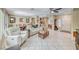 Bright and airy living room with tile flooring and an open layout to the dining area and kitchen at 1862 Redwood Valley St, Henderson, NV 89052