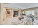Open-concept living room with tile flooring, ceiling fan, and views into the adjacent dining area at 1862 Redwood Valley St, Henderson, NV 89052