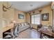 Office with wood floors features a sofa, two desks, a window, and decorative accents at 1862 Redwood Valley St, Henderson, NV 89052