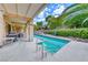 Wonderful pool area featuring a covered patio, barbecue area, tropical plants and lush hillside landscaping at 1862 Redwood Valley St, Henderson, NV 89052