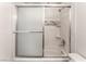 Well-maintained bathroom showcasing a shower-tub combo with a tiled surround and sliding door at 221 Mission Catalina Ln # 104, Las Vegas, NV 89107