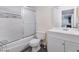 Clean bathroom featuring a shower-tub combo with sliding glass doors and a white vanity at 221 Mission Catalina Ln # 104, Las Vegas, NV 89107