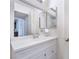 Bright bathroom featuring a vanity with a large mirror, storage, and a white color scheme at 221 Mission Catalina Ln # 104, Las Vegas, NV 89107