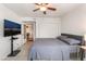 Comfortable bedroom featuring a ceiling fan, tiled floor, and neutral decor at 221 Mission Catalina Ln # 104, Las Vegas, NV 89107