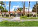 Exterior view of a red-roofed building framed by tall palm trees and manicured green lawns at 221 Mission Catalina Ln # 104, Las Vegas, NV 89107
