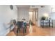 Bright dining area featuring a table set, wood floors, and access to kitchen and bathroom at 221 Mission Catalina Ln # 104, Las Vegas, NV 89107