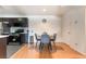 Cozy dining area featuring a modern table set with nearby kitchen and wood floors at 221 Mission Catalina Ln # 104, Las Vegas, NV 89107