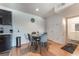 Bright dining area featuring a table set, wood floors, and access to kitchen and bathroom at 221 Mission Catalina Ln # 104, Las Vegas, NV 89107